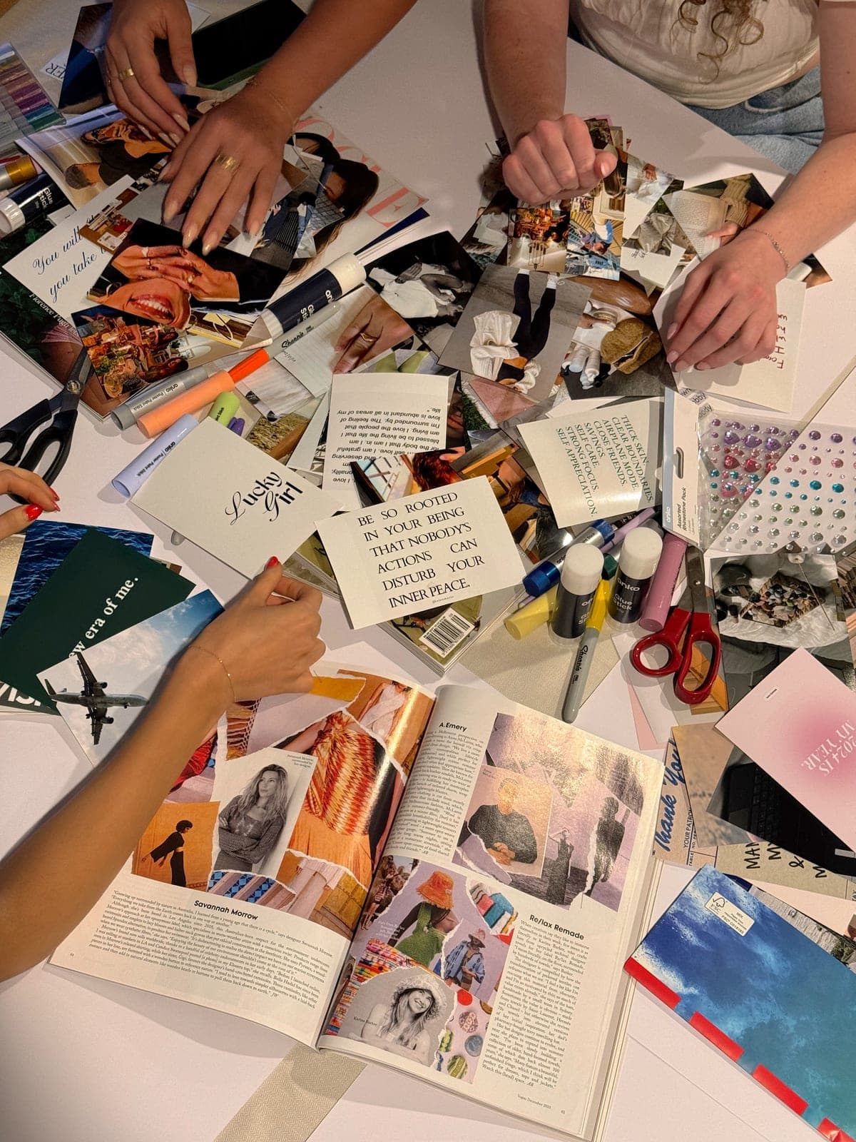 Hands at a table, the curation in progress